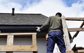 Construction Worker Installing Plastic Roof Rain Gutter Gray Shi