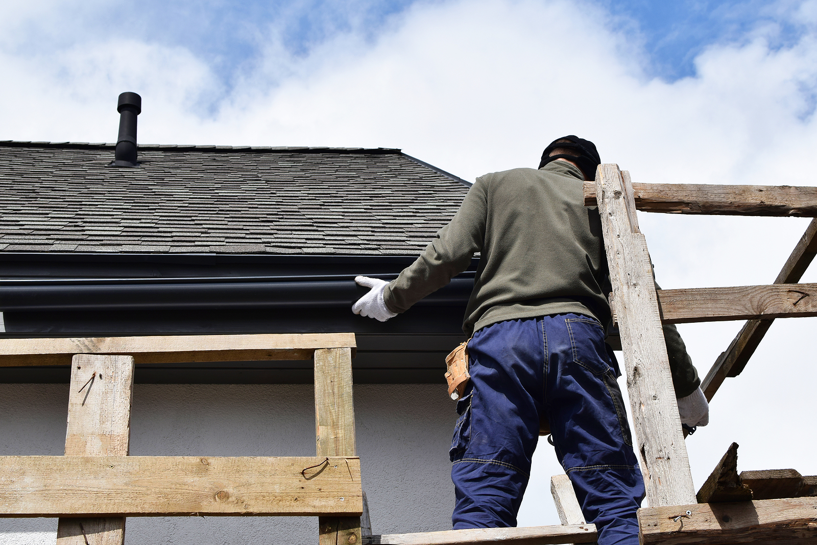 Construction Worker Installing Plastic Roof Rain Gutter Gray Shi