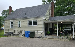 Home with an asphalt shingle roof illustrating the importance of addressing roof leaks quickly