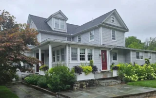 Connecticut home with an asphalt shingle roof highlighting residential roofing CT maintenance to help protect the roof from seasonal weather.